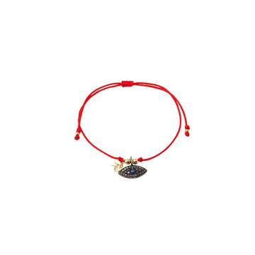 Red string bracelet with solitary silver God eye